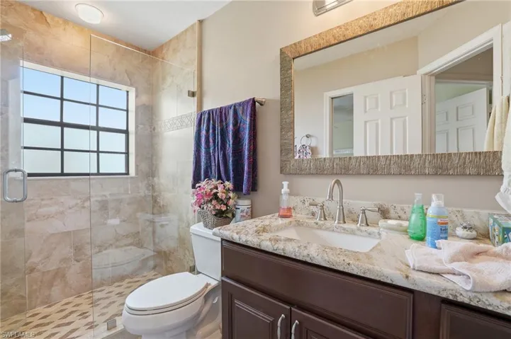 Full bathroom featuring a shower stall and vanity