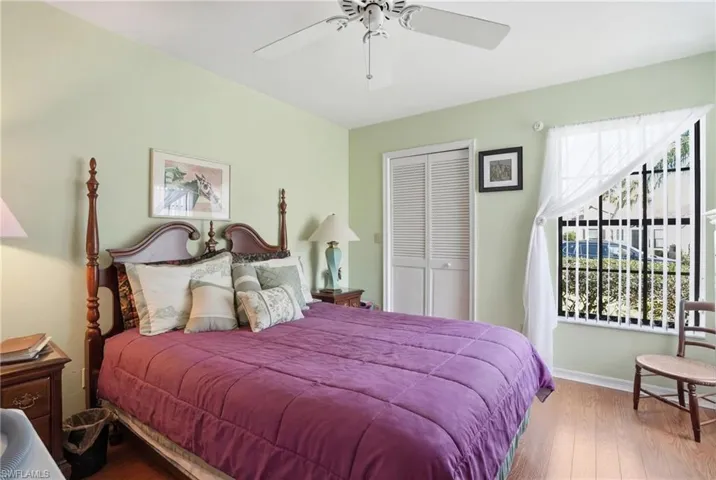 Bedroom featuring wood finished floors, a closet, and ceiling fan