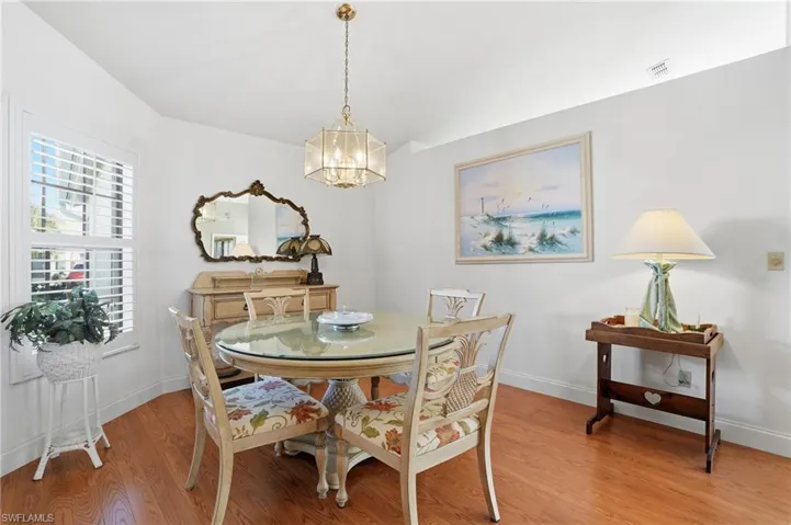 Dining space featuring light wood-style flooring and hanging lights