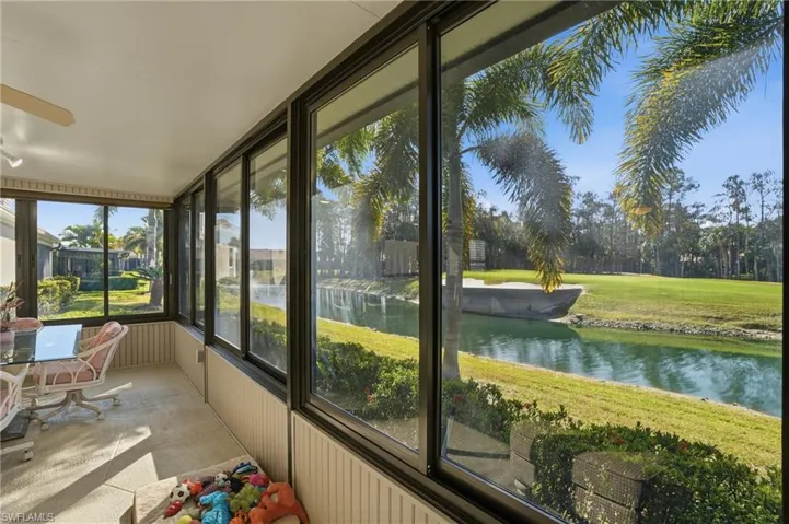Sunroom featuring a water view