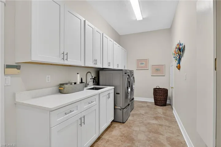 Laundry area with cabinet space and washing machine and dryer