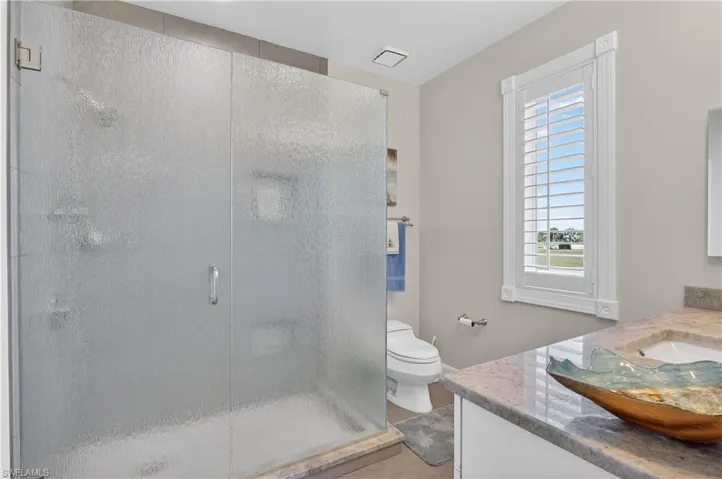 Full bath with vanity and a shower stall