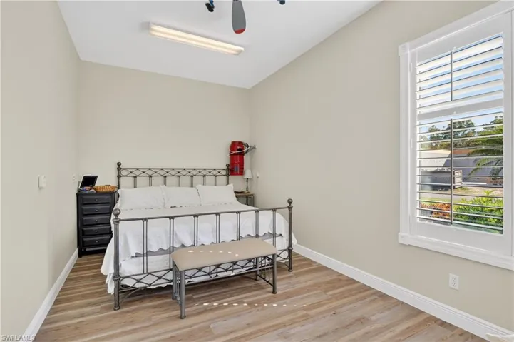 Bedroom with light wood-style flooring and a ceiling fan