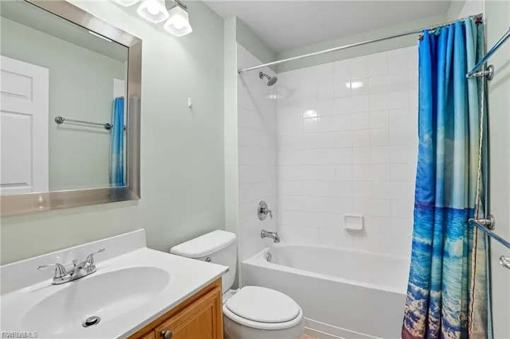 Bathroom with vanity and shower / bath combination with curtain
