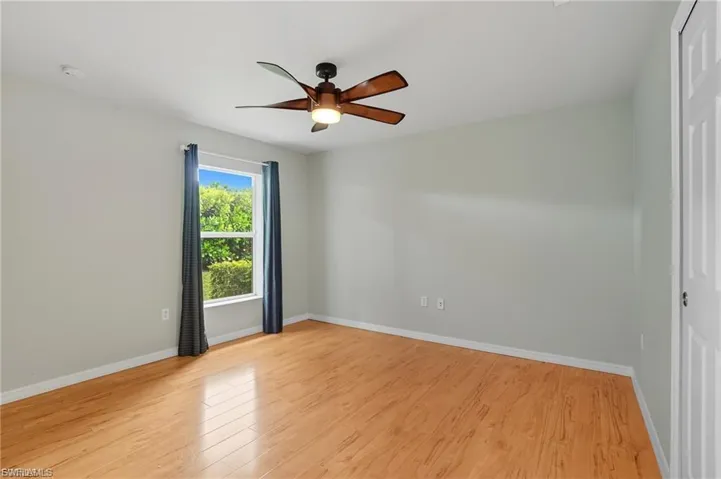 Unfurnished room with light wood-style floors and ceiling fan