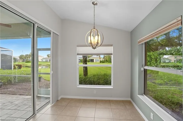 Unfurnished dining area featuring light tile patterned floors and suspended lighting