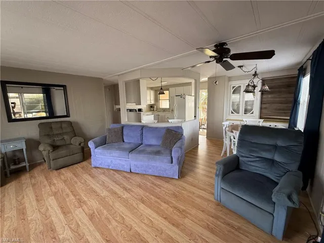 Living room with a ceiling fan and light wood-style floors