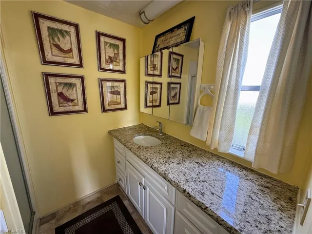 Bathroom with vanity and stone tile floors