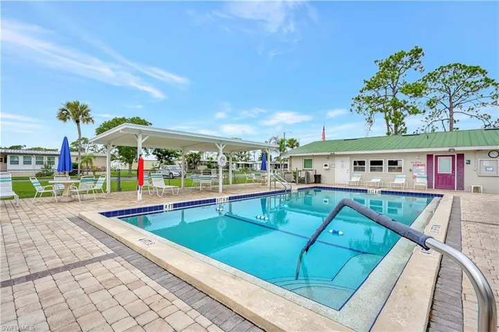 Community pool with a patio