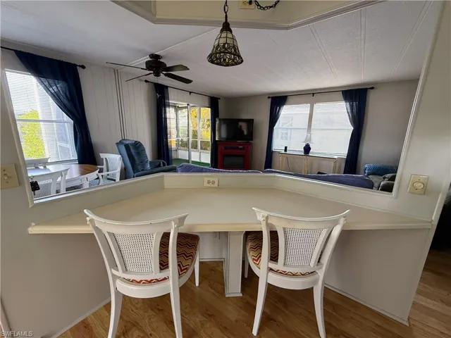 Dining area with light wood-style floors and a ceiling fan