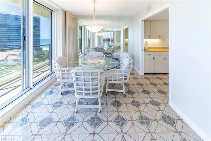 Tiled dining room featuring plenty of natural light