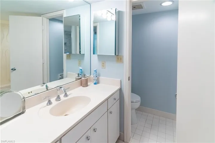Bathroom featuring vanity, tile patterned floors, and toilet
