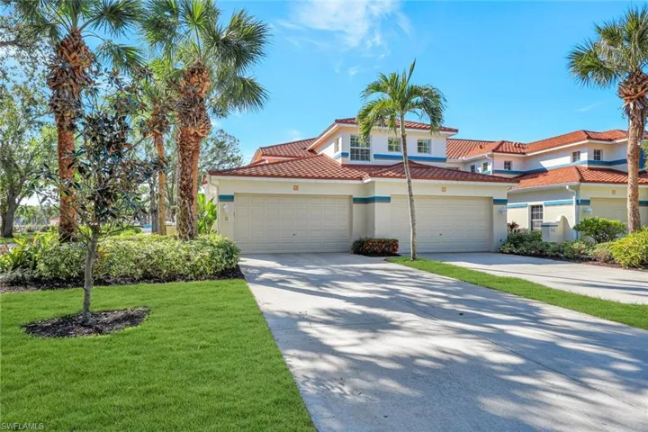 Mediterranean / spanish home with a garage and a front yard