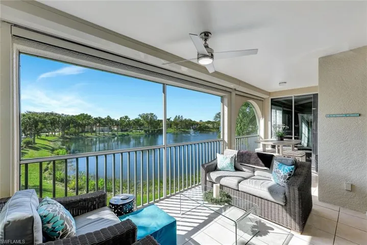 Sunroom / solarium featuring a water view and ceiling fan