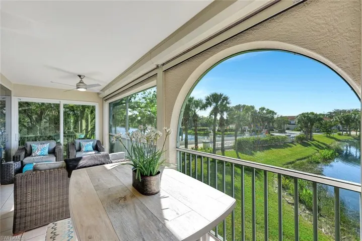 Sunroom / solarium featuring a water view and ceiling fan