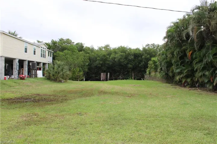 View of grassy yard, facing the water.