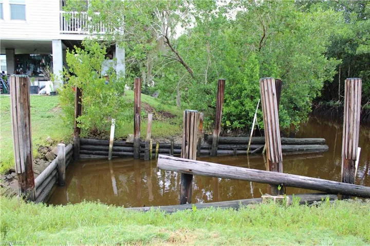 Boat slip area with a water view and a wooded view.