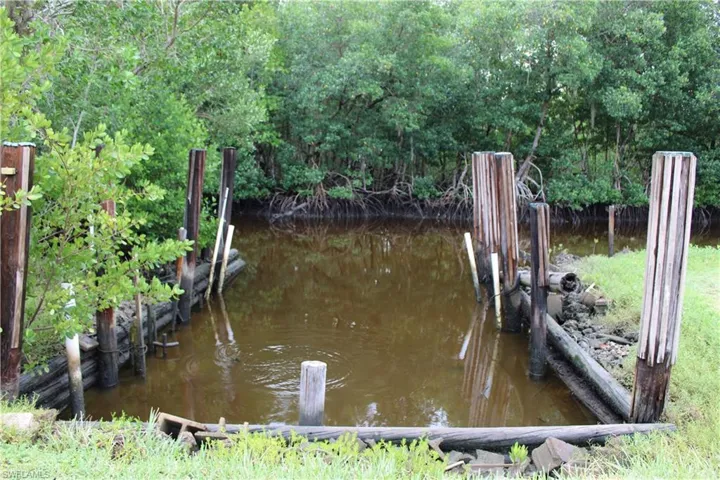 Boat slip area with a view of trees and a water view.