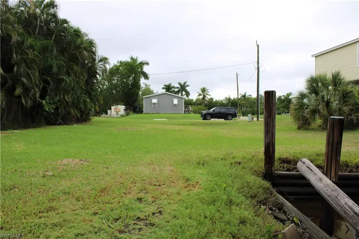 View of grassy yard, looking toward road.