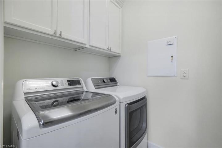 Full size laundry with laundry sink and storage