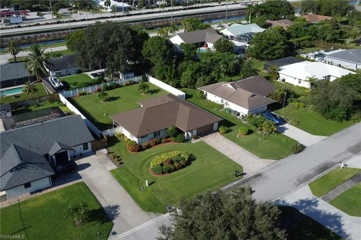 Aerial view of property's location featuring nearby suburban area