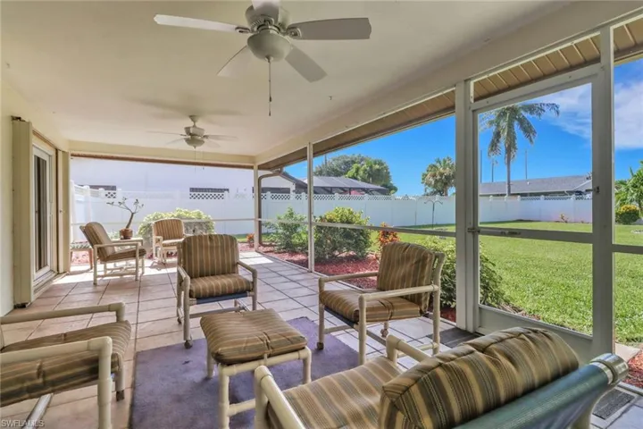 Sunroom / solarium with outdoor lounge area, ceiling fan, and tile patterned floors
