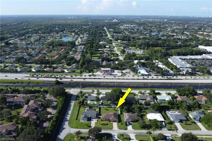 Aerial view of property's location with nearby suburban area