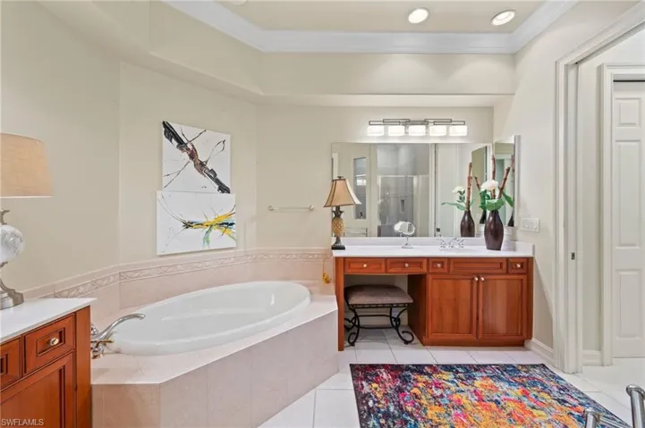 Bathroom featuring vanity, and separate shower and tub