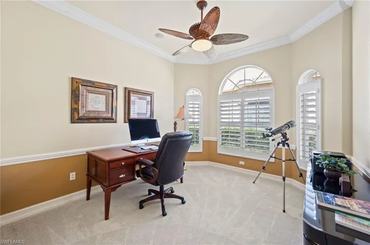 Carpeted office or Bedroom featuring ceiling fan and ornamental molding