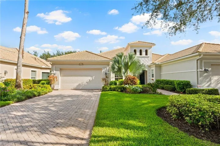 Mediterranean / spanish home with a garage and a front yard