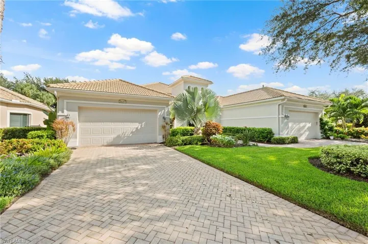 Mediterranean / spanish-style house with a front yard and a garage