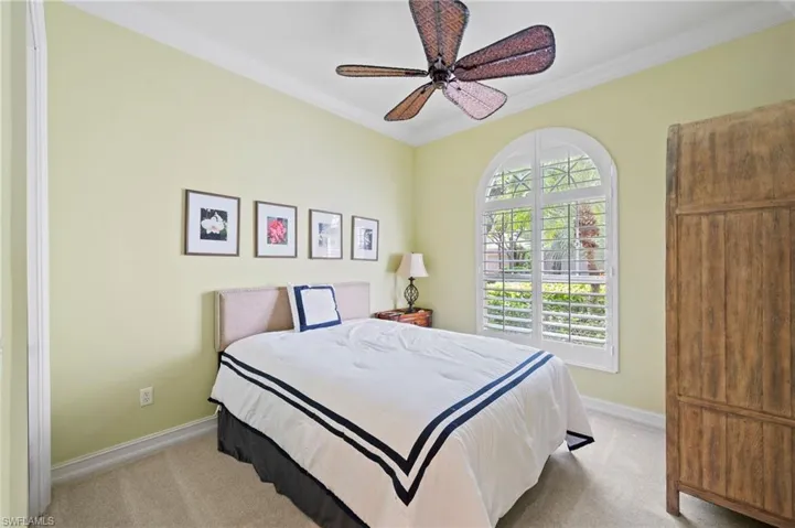 Carpeted office or Bedroom featuring ceiling fan and ornamental molding