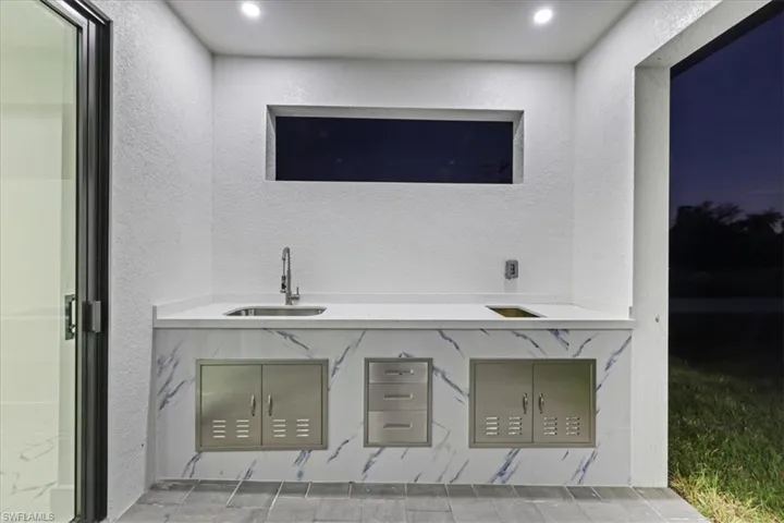 Bar featuring a sink and a textured wall