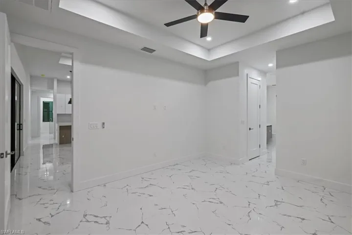 Spare room with marble finish floor, recessed lighting, baseboards, and ceiling fan