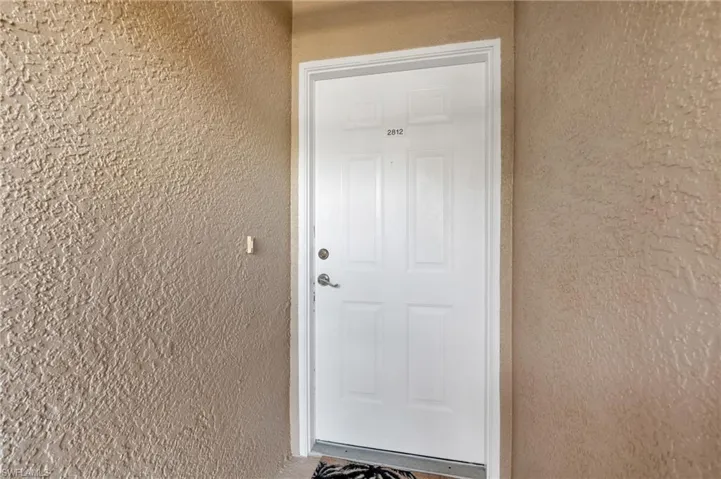 Property entrance featuring stucco siding