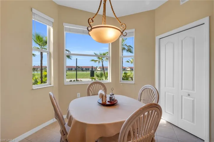 Dining space featuring light tile patterned floors and baseboards