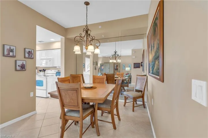 Dining area with a chandelier and light tile patterned floors