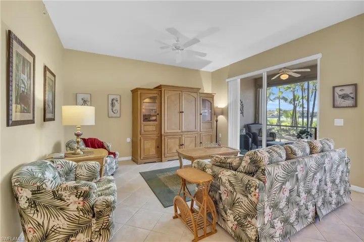 Living room featuring ceiling fan and light tile patterned flooring