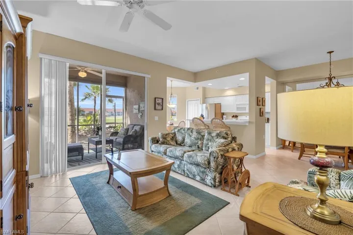 Living room featuring light tile patterned flooring and recessed lighting