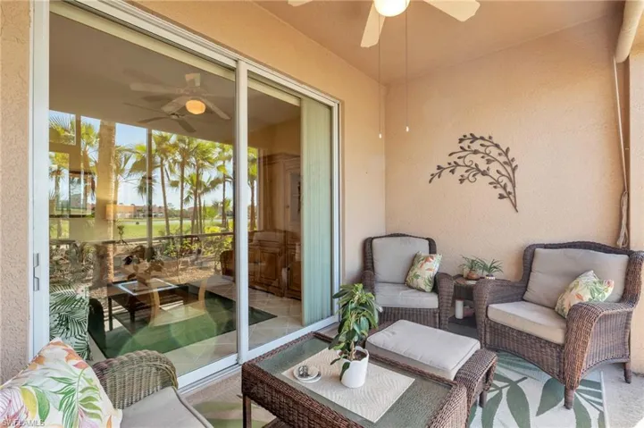 Sunroom / solarium with a ceiling fan and outdoor lounge area
