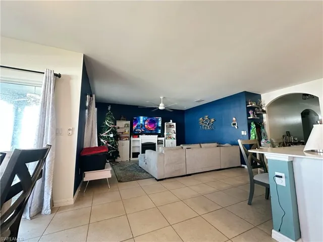 Tiled living room featuring ceiling fan