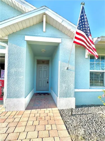 Entrance to property featuring stucco siding