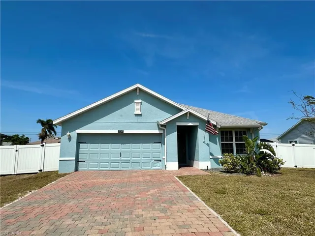 Single story home with a gate, fence, decorative driveway, a front yard, and stucco siding