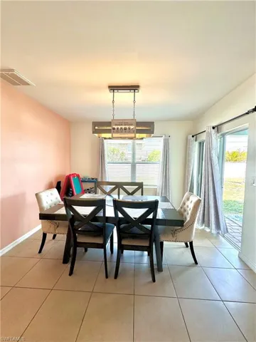 Dining room with baseboards, visible vents, and light tile patterned floors