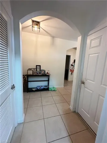 Hallway with light tile patterned flooring