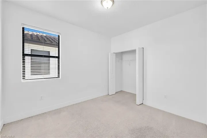 bedroom featuring carpet and a closet