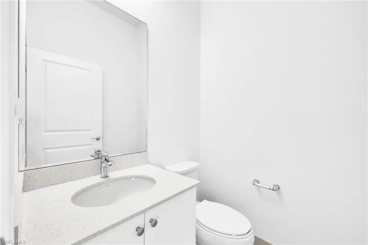 First Floor Half bath with vanity and toilet