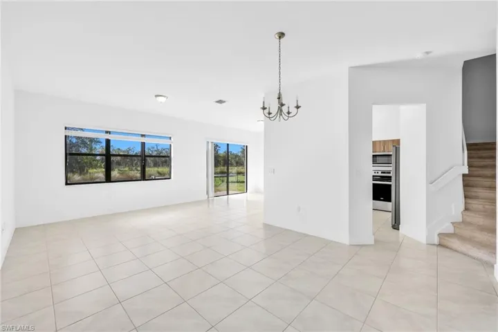 Living/Dining area featuring hanging lights and light tile patterned flooring