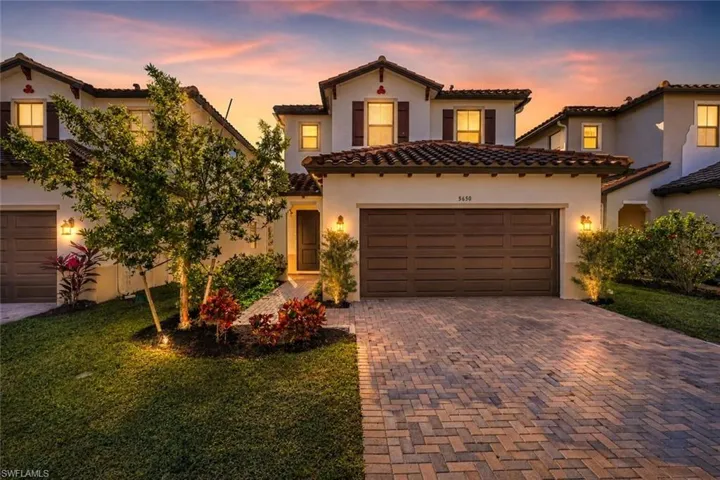 Mediterranean / spanish house with stucco siding, decorative driveway, and a tiled roof
