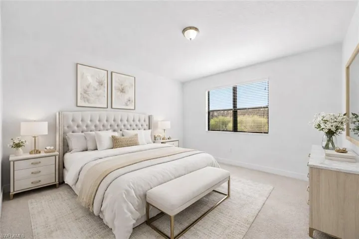 VIRTUALLY STAGED-Bedroom featuring light carpet and baseboards